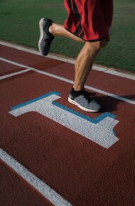 person running on tracking field