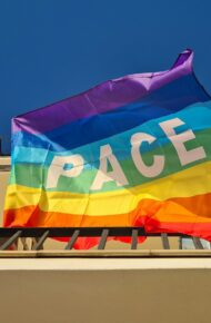 a rainbow flag with the word peace on it